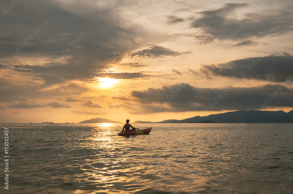 Seascape, a guy kayaking in ocean in sunset at tropical ocean in Thailand, travel vacation holidays concepts