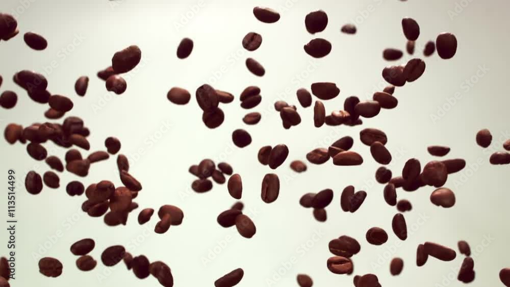 Coffee beans are flying in the air on a white background Coffee beans are flying in the air on a white background