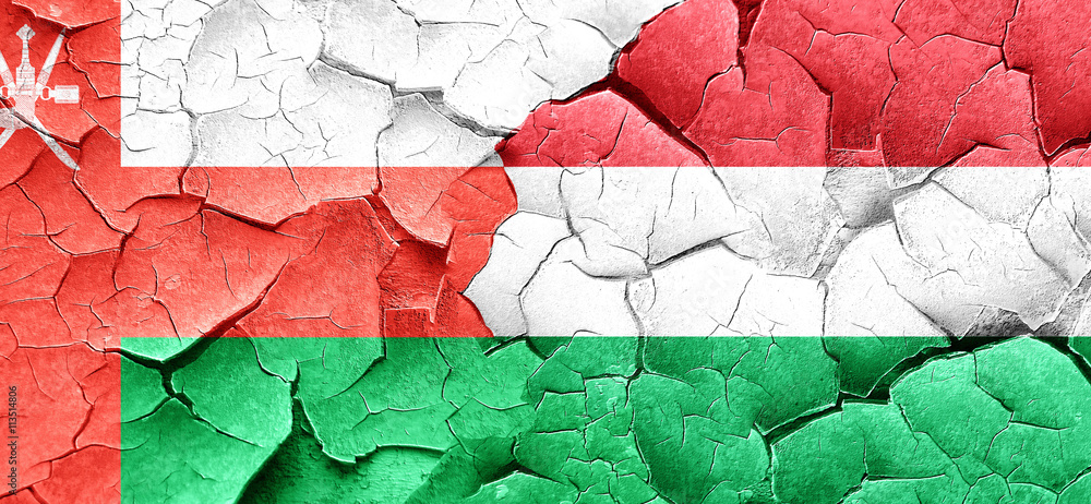 Oman flag with Hungary flag on a grunge cracked wall
