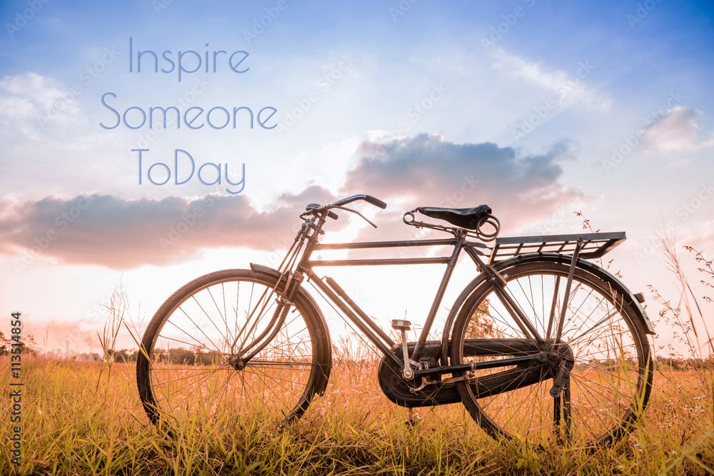 beautiful landscape image with Bicycle at sunset in vintage tone style ; life quote. Inspirational quote. Motivational background beautiful landscape image with Bicycle at sunset in vintage tone style ; life quote. Inspirational quote. Motivational background
