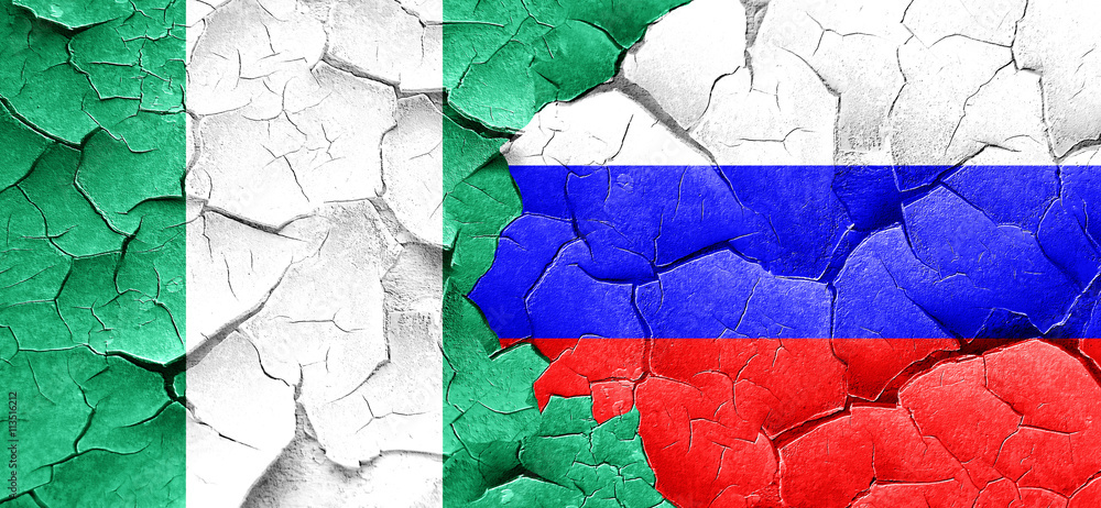 Nigeria flag with Russia flag on a grunge cracked wall