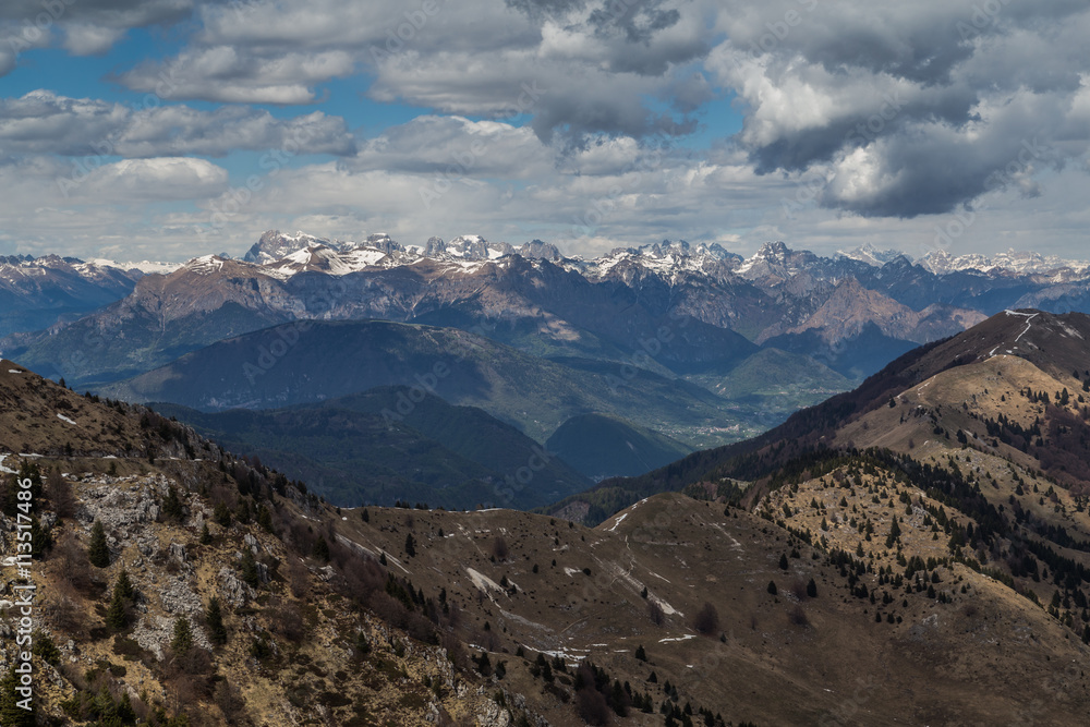 Panoramic view of some snowy peaks of the Dolomites as seen from Monte del Grappa, Italy