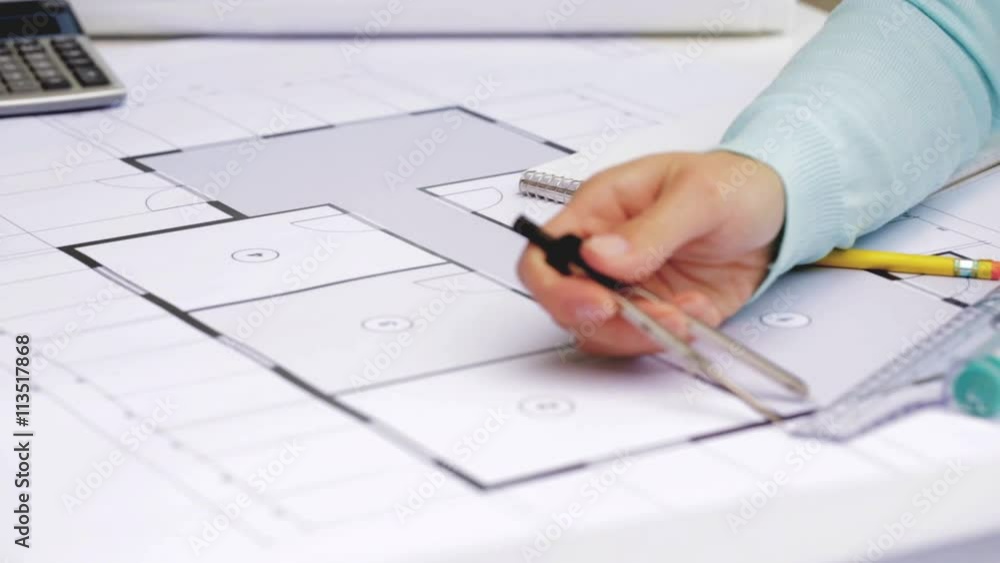 architect woman measuring blueprint with compass architect woman measuring blueprint with compass