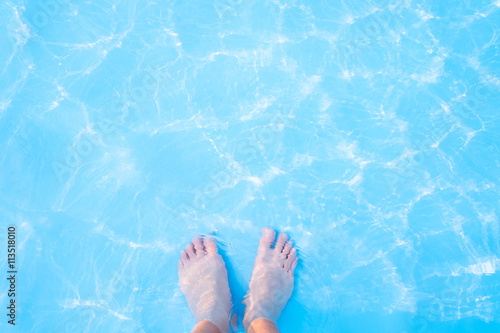 Barefoot and blue swimming pool