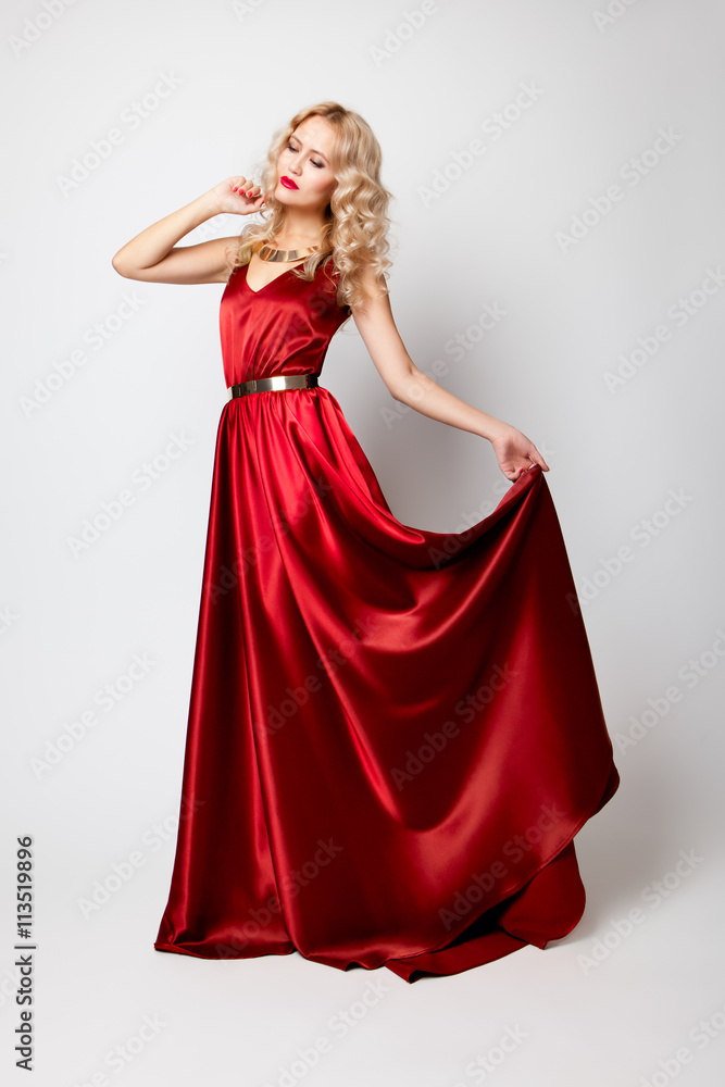 Beautiful woman model posing in red dress