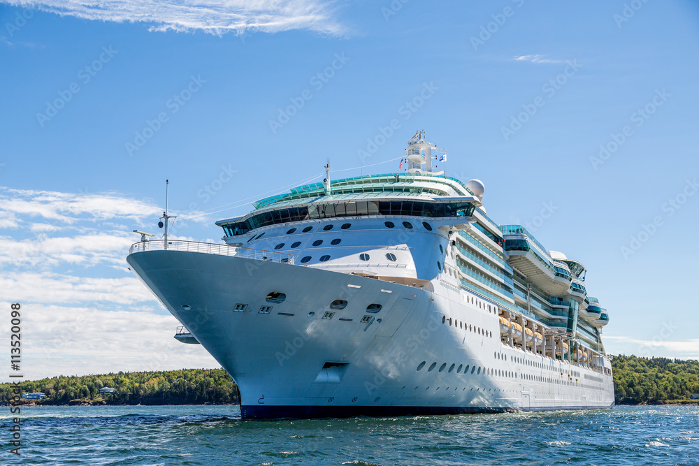 Massive Cruise Ship on Blue water by Green Island