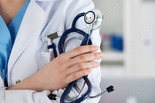 Closeup of female medicine therapeutist doctor standing with han