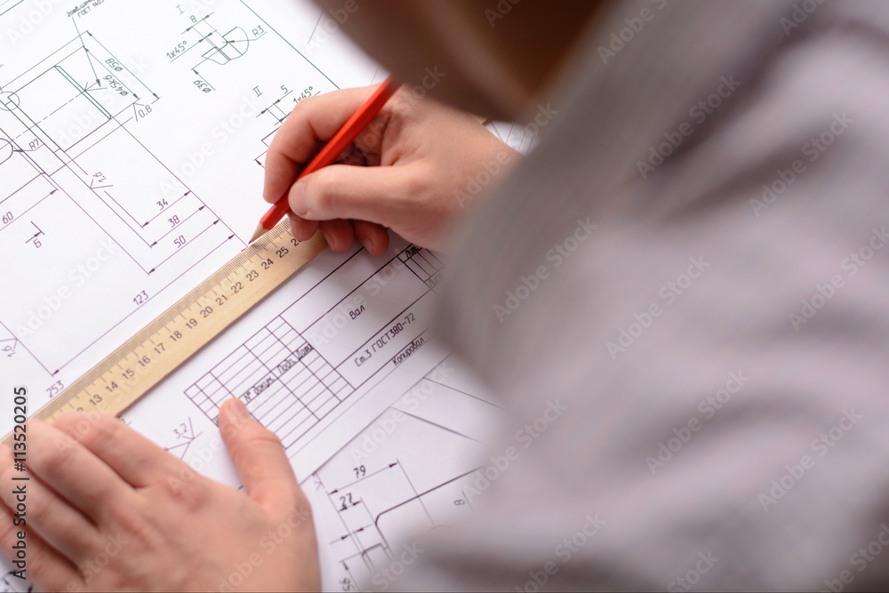 Mechanical engineer at work. Technical drawings. Paper with technical drawings and diagrams. Mechanical engineer at work. Technical drawings. Paper with technical drawings and diagrams.
