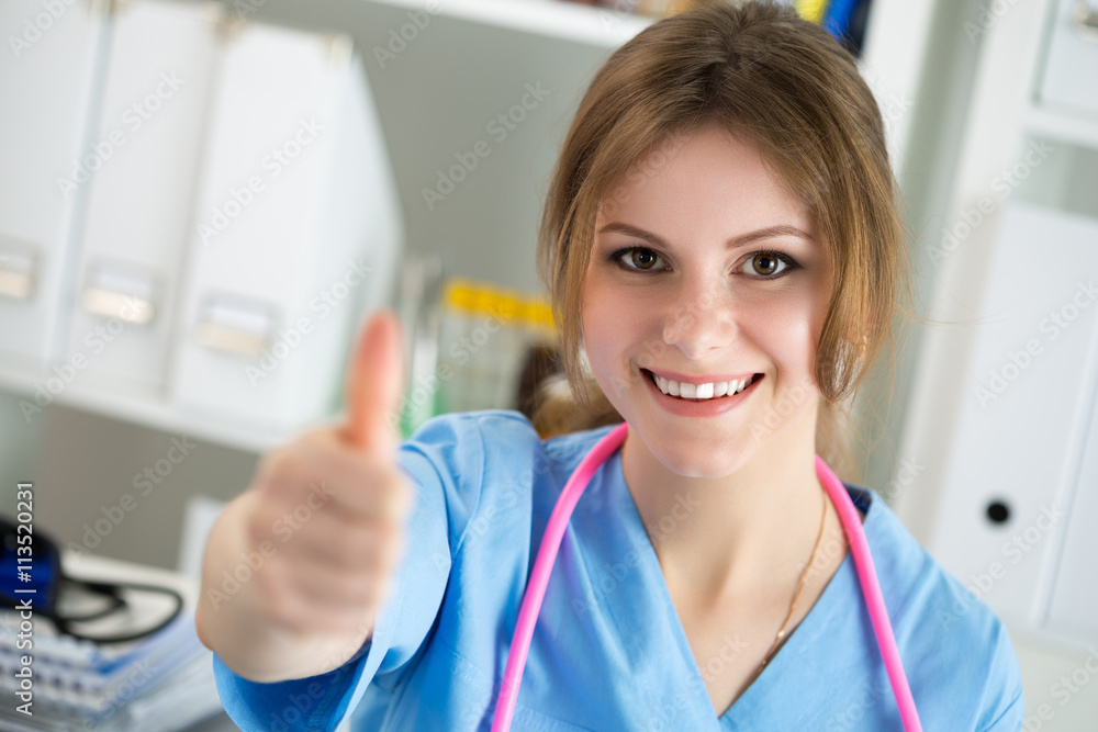 Female medicine doctor showing ok sign with thumb up Female medicine doctor showing ok sign with thumb up
