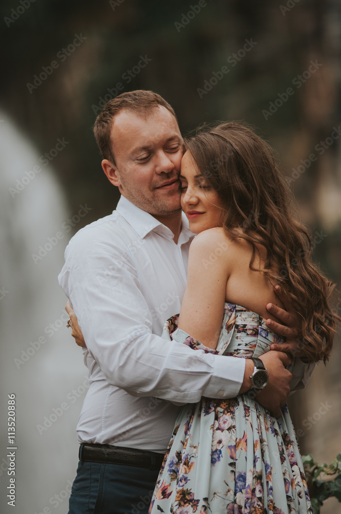 Young cute couple honeymoon standing near waterfall holding their hands on dating in a beautiful place italy near ocean and mountains, hug, smile and talk to each other
Young cute couple honeymoon standing near waterfall holding their hands on dating in a beautiful place italy near ocean and mountains, hug, smile and talk to each other