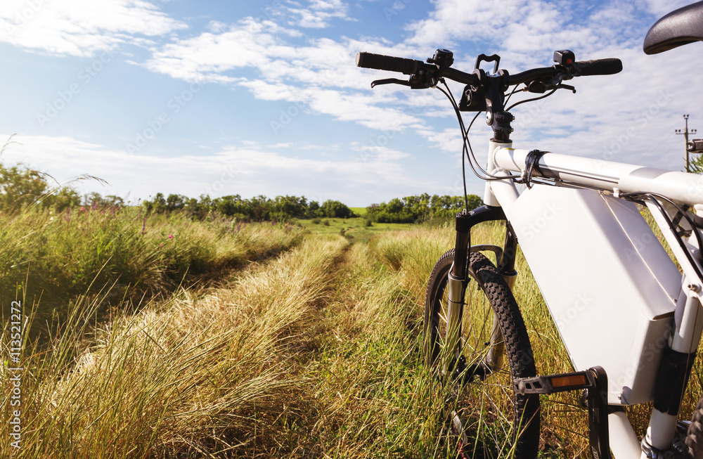 Mountain bicycle at sunny day on the dirt road Mountain bicycle at sunny day on the dirt road
