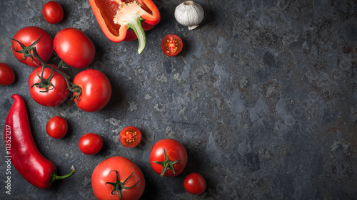 Ingredients for gazpacho soup on a gray slate