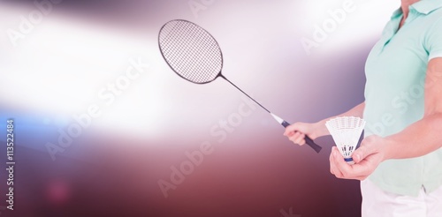 Pretty blonde playing badminton  against spotlights © vectorfusionart