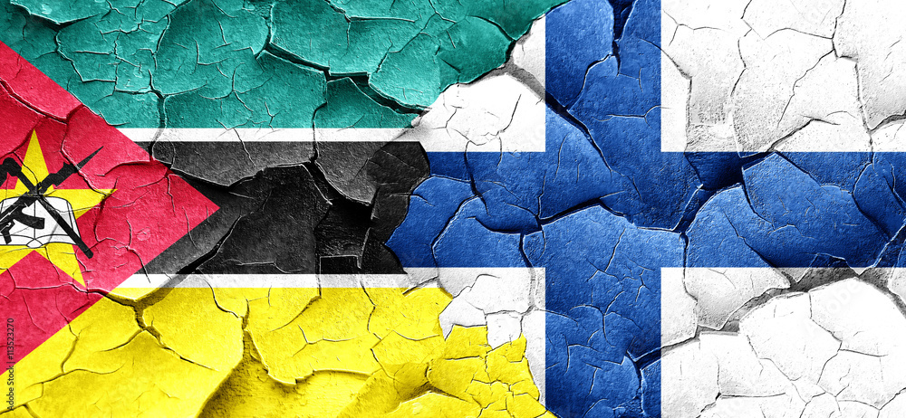 Mozambique flag with Finland flag on a grunge cracked wall