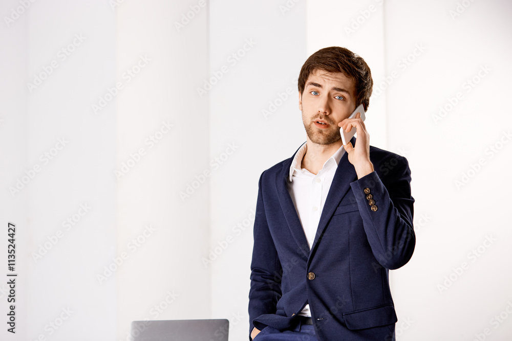 Young businessman talking on his phone Young businessman talking on his phone
