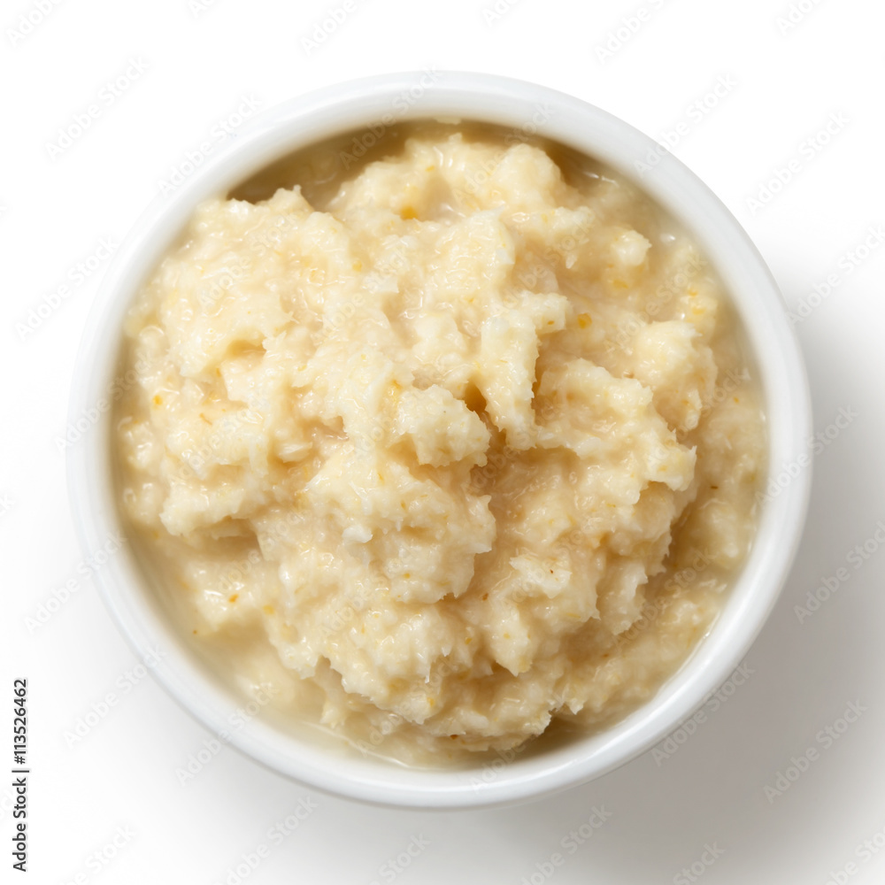 Horseradish sauce in white bowl from above on white. Horseradish sauce in white bowl from above on white.