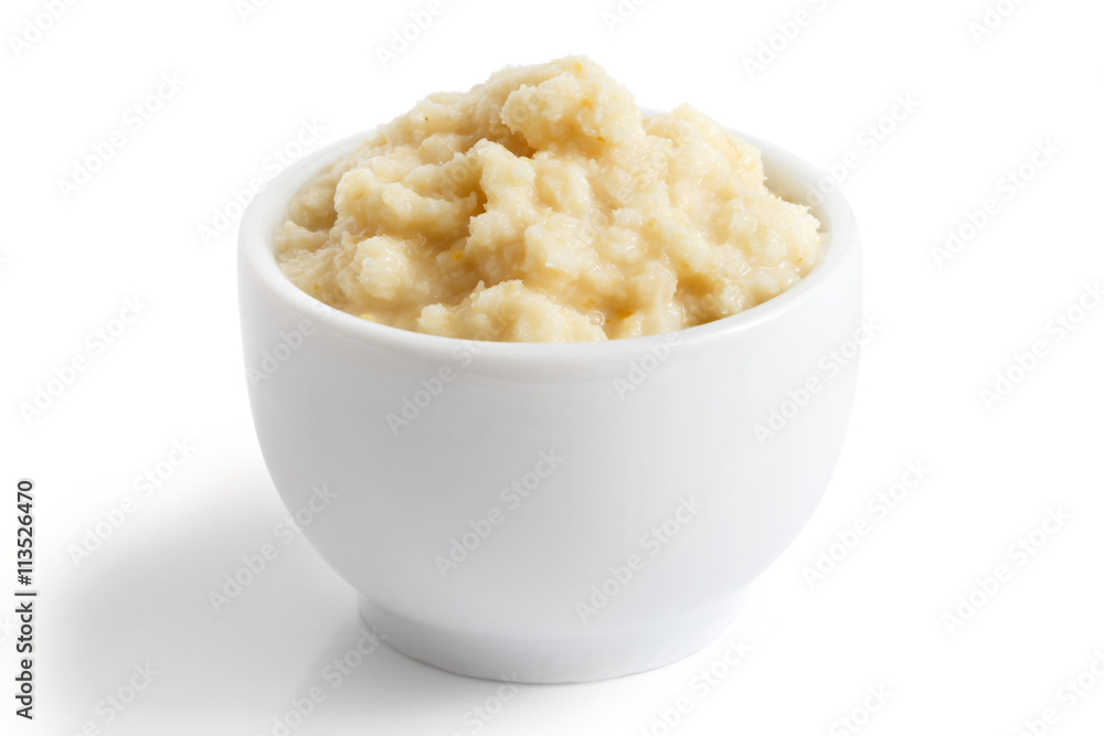 Horseradish sauce in small white bowl in perspective on white. Horseradish sauce in small white bowl in perspective on white.