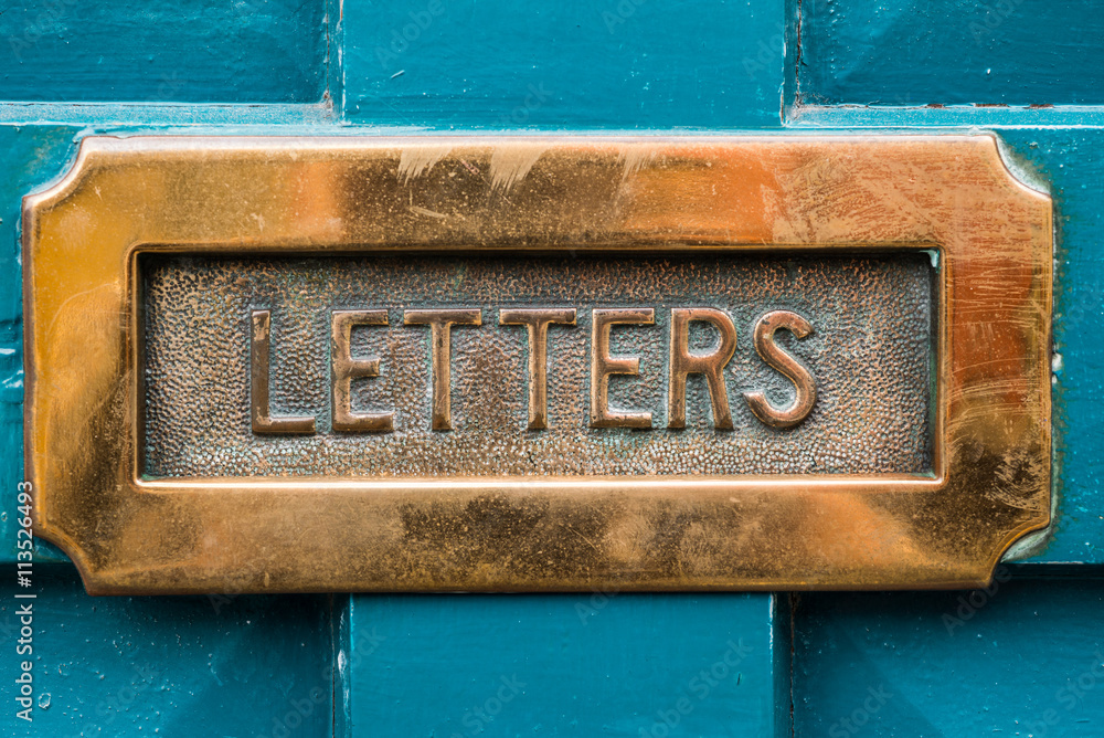 Fototapeta premium Vintage brass letterbox on blue door background