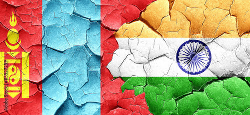 Mongolia flag with India flag on a grunge cracked wall