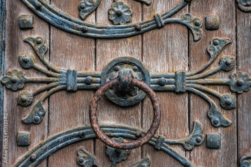 Rusty door knocker on old church door