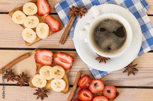 coffee and toast with strawberries and bananas