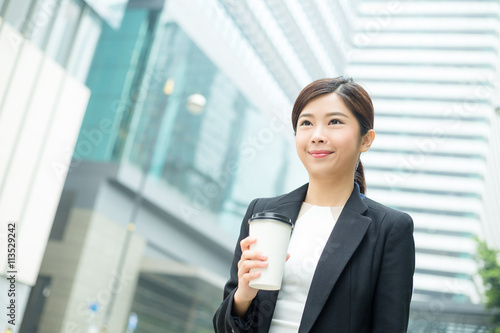 Asian Business woman holding a cup of coffee