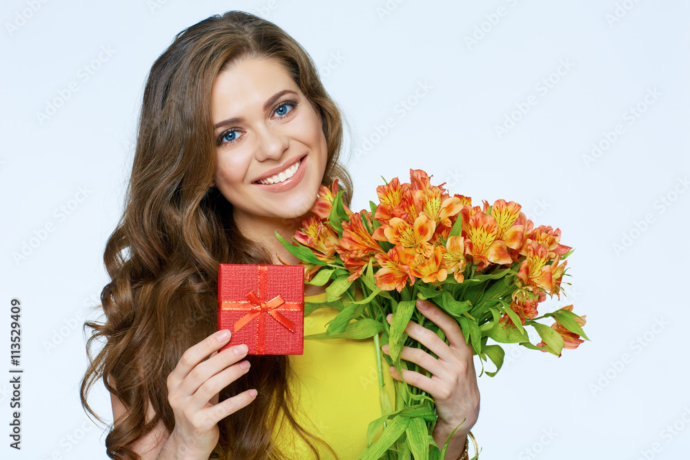 Happy smiling woman holding presents. Flowers and gift box. Happy smiling woman holding presents. Flowers and gift box.