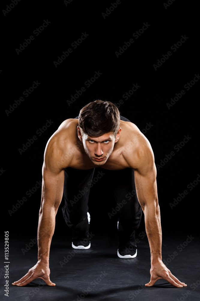 Athlete prepare to run over black background