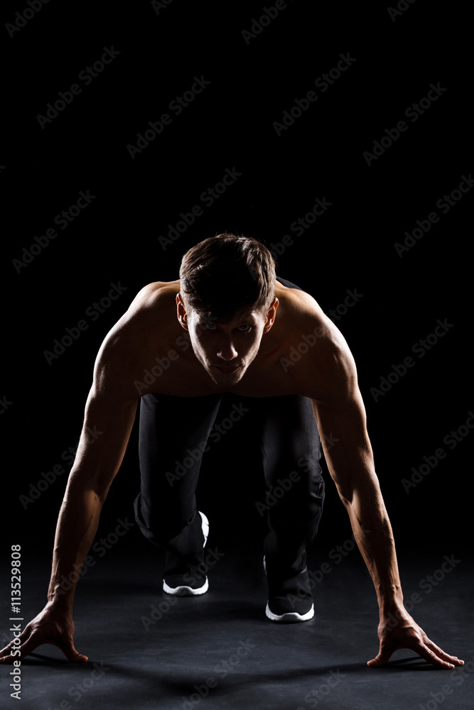 Athlete prepare to run over black background