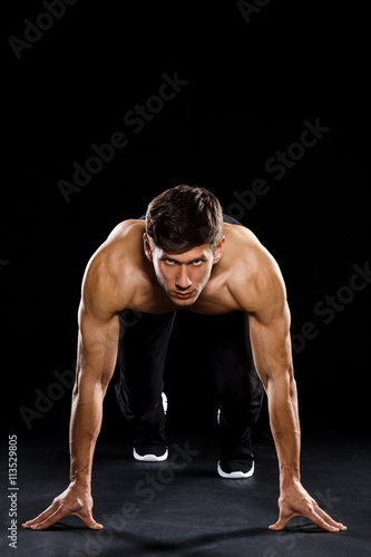 Athlete prepare to run over black background