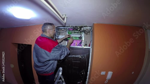Electrician Trimming Electrical Wires Before Fixing to a Electrical Breaker Panel / 