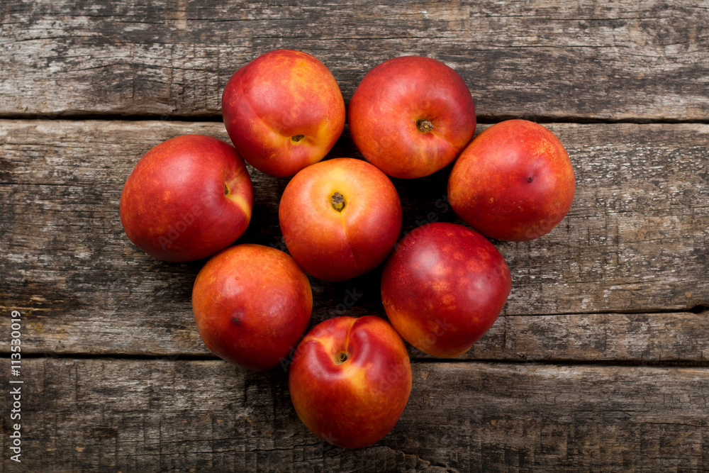 The simple food composition with nectarines on the unique backing closeup The simple food composition with nectarines on the unique backing closeup