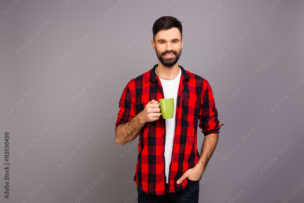Happy pretty man holding cup of hot tea Happy pretty man holding cup of hot tea