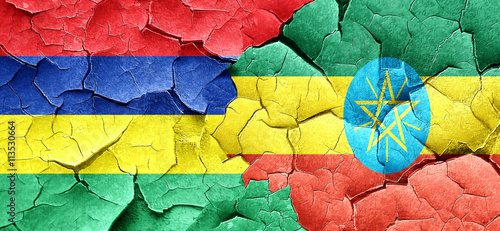 Mauritius flag with Ethiopia flag on a grunge cracked wall