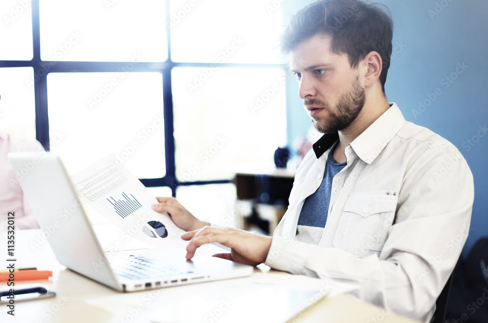 Elegant businessman analyzing data in office