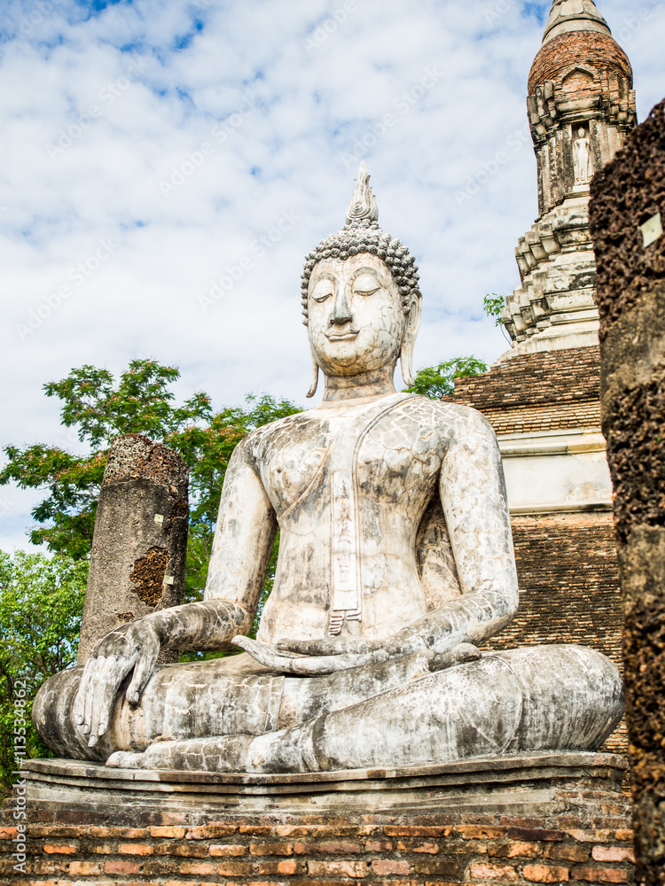 Buddha statue at Wat Traphang Ngoen, an ancient temple in Sukhothai Historical Park, Sukhothai, Thailand. 