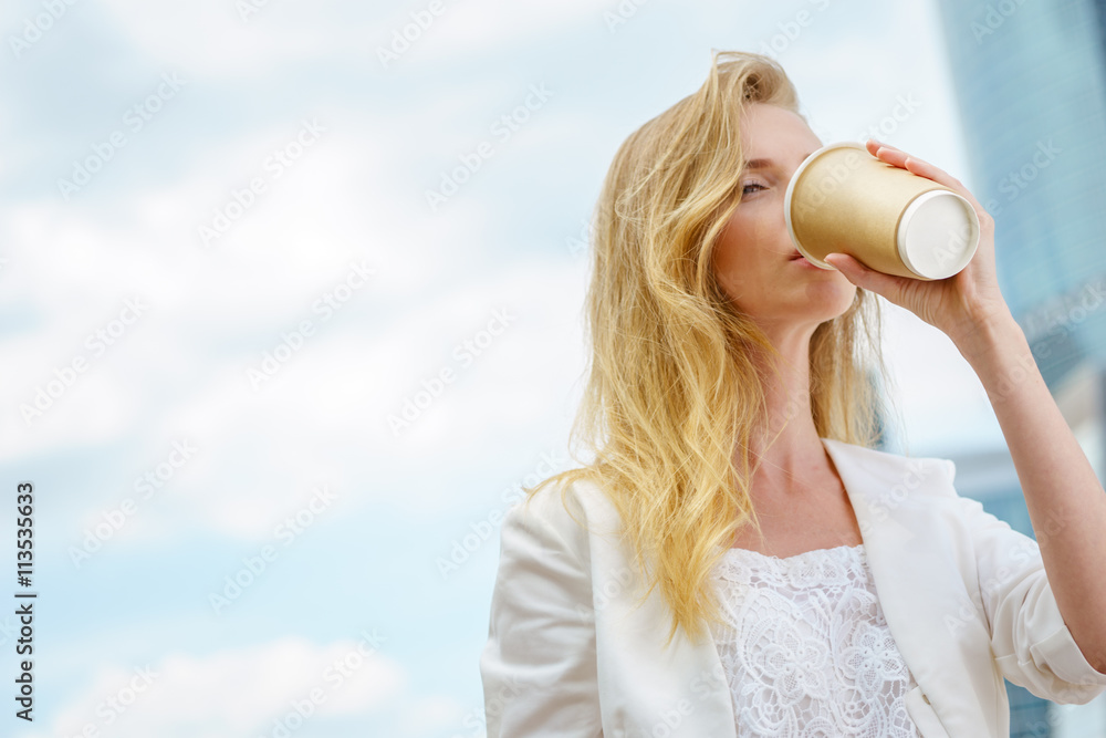 young girl in drinking coffee in the street young girl in drinking coffee in the street