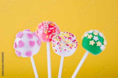 Cake pops on yellow background

