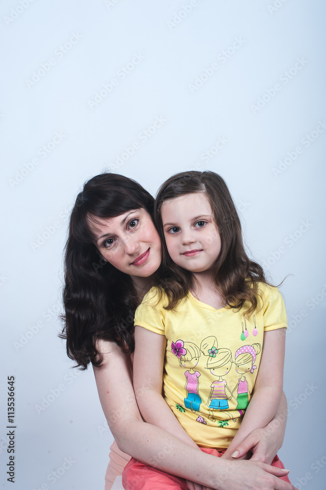 the daughter and mother together in each other's arms on a white background the daughter and mother together in each other's arms on a white background