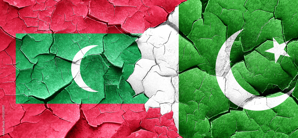 Maldives flag with Pakistan flag on a grunge cracked wall