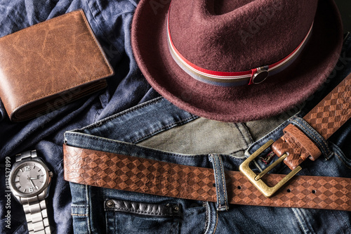 Various fashions of fedora hat, wallet, wrist watch and blue jea photo