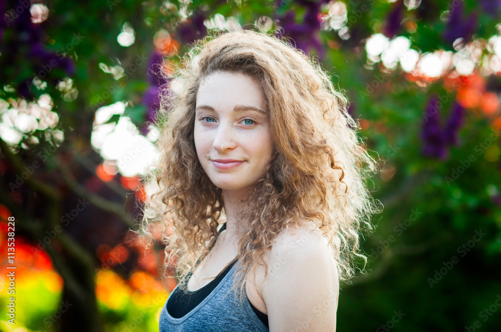 blue eyed curly haired teenage girl outdoors on a summer evening blue eyed curly haired teenage girl outdoors on a summer evening