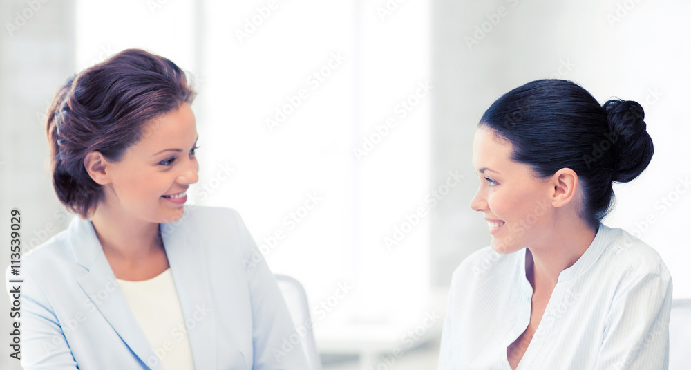two businesswomen having discussion in office two businesswomen having discussion in office