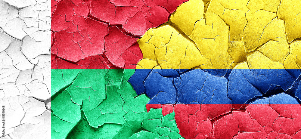 Madagascar flag with Colombia flag on a grunge cracked wall