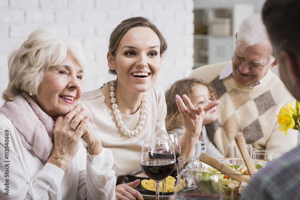 Family talking and enjoying dinner Family talking and enjoying dinner