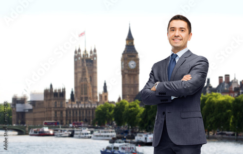 Photography happy smiling businessman in suit over london city