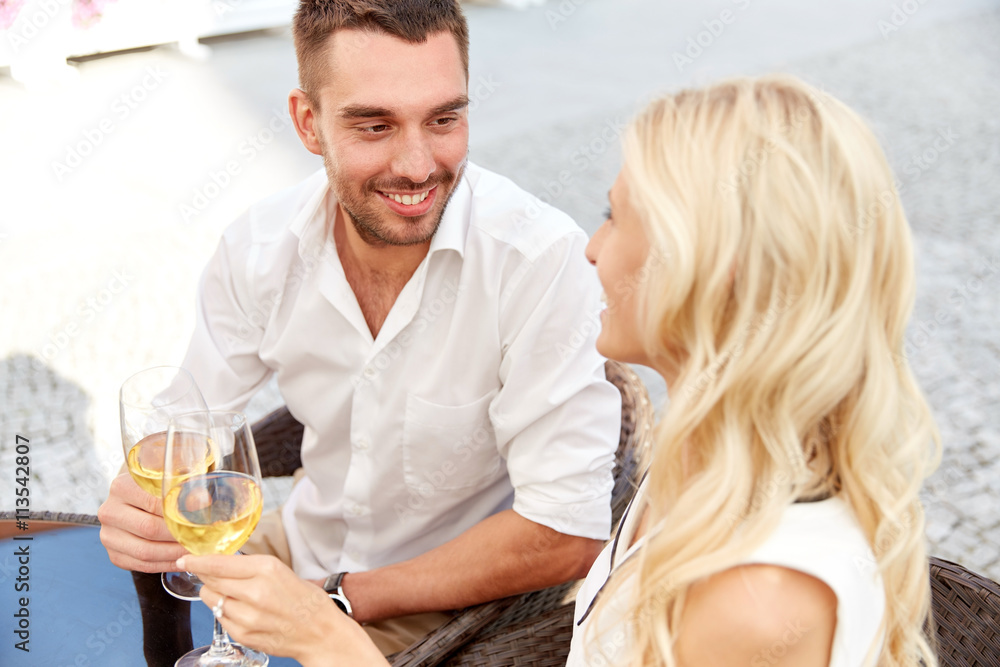 happy couple drinking wine at open-air restaurant happy couple drinking wine at open-air restaurant