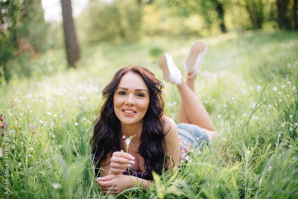 sunny summer day, a beautiful young woman lying on the grass sunny summer day, a beautiful young woman lying on the grass