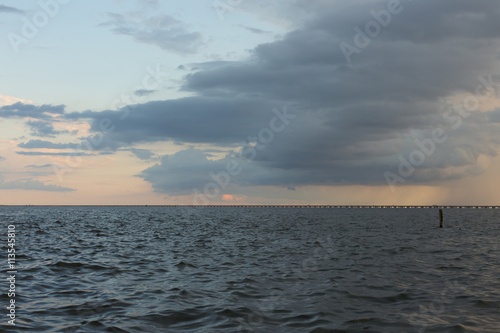 Rain storm rolling in at sunset over Lake Pontchartrain bridge