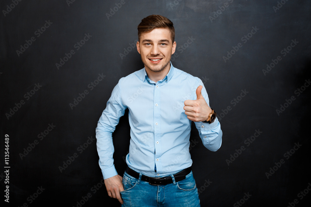 happy man over blackboard. thumbs up happy man over blackboard. thumbs up